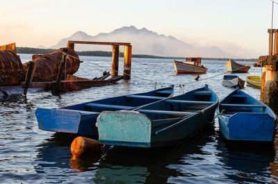 Boats moored in sea against sky