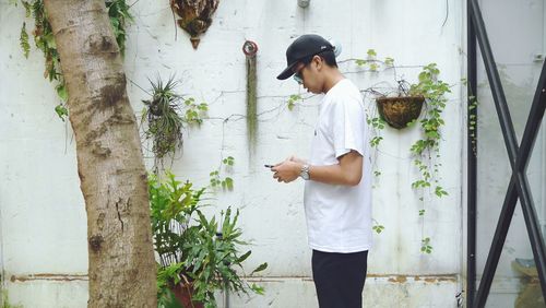 Full length of woman standing against plants