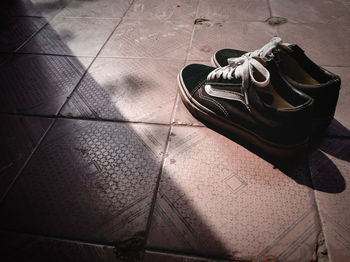 High angle view of shoes on tiled floor