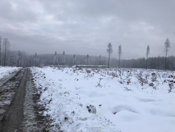 Snow covered land against sky