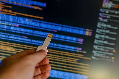 Cropped hand of man using usb key