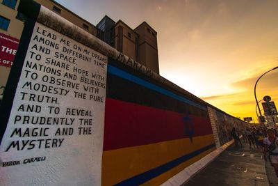 Information sign against sky at sunset