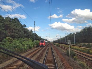 Railroad track against cloudy sky