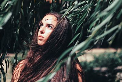 Attractive woman in lush foliage