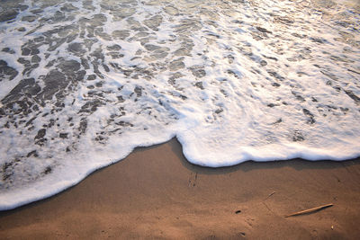 White wave of blue sea on sandy beach. natural background