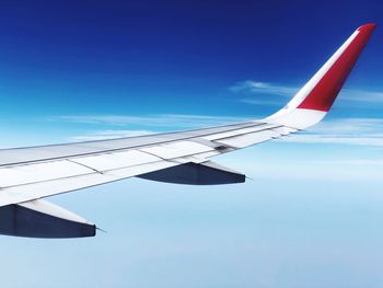 Low angle view of airplane flying against sky