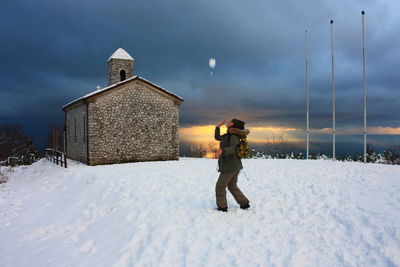 Full length of man on snow field against sky