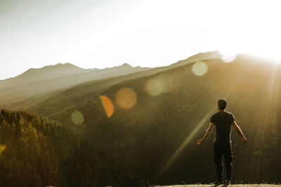 Rear view of man looking at mountains