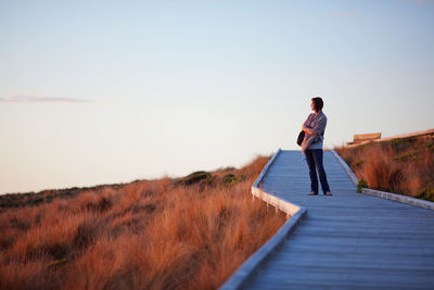 Woman standing on boardwalk