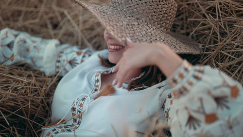 Cropped hand of woman wearing hat