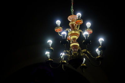 Low angle view of illuminated light bulbs