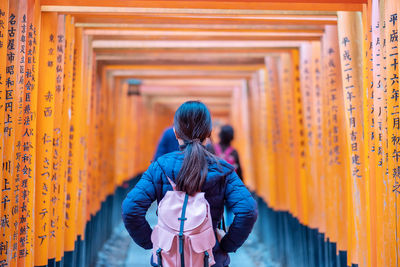 Rear view of women standing outside temple