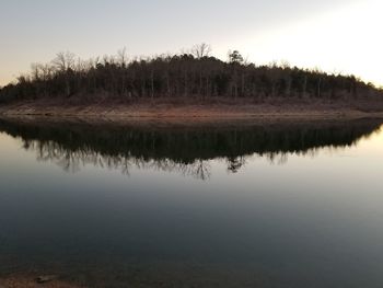 Reflection of trees in lake against sky