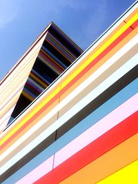 Low angle view of modern building against blue sky