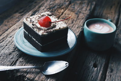 Close-up of coffee and cake on wooden table