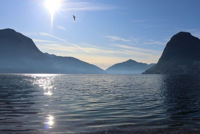 Scenic view of sea and mountains against sky