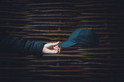 Close-up of man holding cap