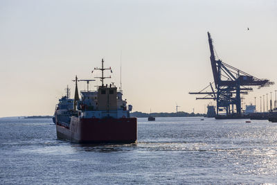 Ship sailing in sea against clear sky