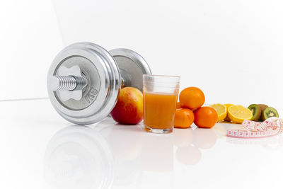 Various fruits on table against white background