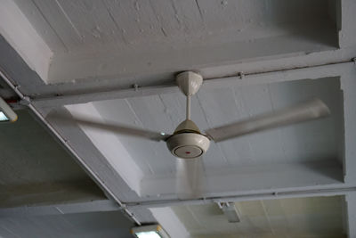 Low angle view of electric lamp hanging from ceiling