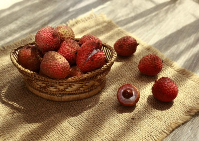 High angle view of strawberries in basket on table