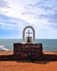 Built structure on beach against sky