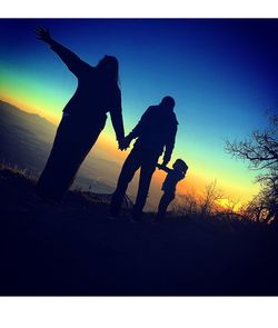 Silhouette of people at sunset