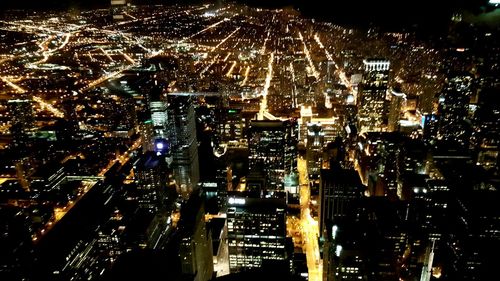 High angle view of city lit up at night