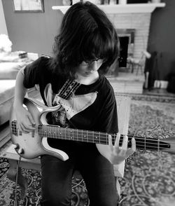 Girl playing guitar at home