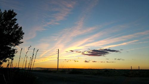 Scenic view of silhouette landscape against sky at sunset