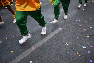 Low section of people dancing on road