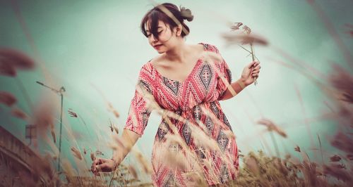 Beautiful woman standing on field