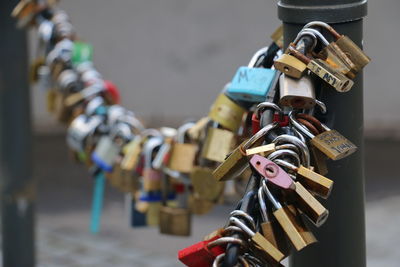 Close-up of padlocks hanging on railing