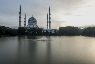 View of mosque and buildings against sky