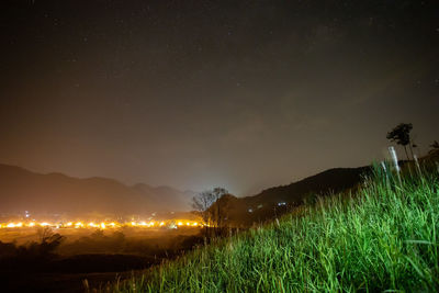 Scenic view of field against sky at night