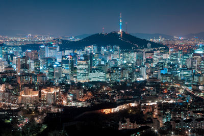 Aerial view of city lit up at night