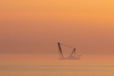 
heavy industry wind turbine installation barge off the dutch coast, building an offshore wind park