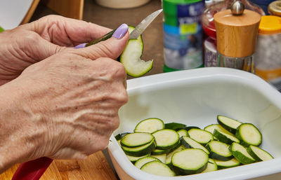 Cropped hand of person preparing food