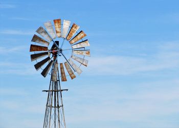 Low angle view of traditional windmill against sky