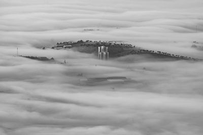 Aerial view of building against cloudy sky