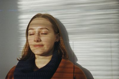 Portrait of a beautiful young woman with eyes closed