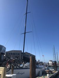 Low angle view of harbor against clear blue sky