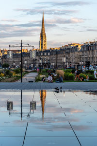 Reflection of buildings on water in city