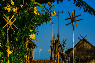 Low angle view of traditional windmill against blue sky