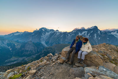 Woman standing on mountain against sky