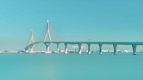 Low angle view of bridge against clear blue sky