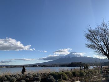 Scenic view of snowcapped mountains against blue sky