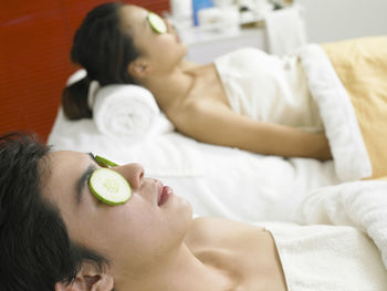 Women having spa treatment while lying on massage table