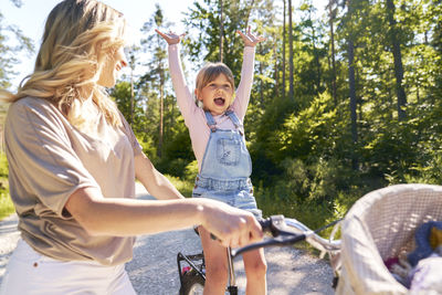 Side view of mother and daughter in park