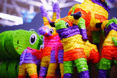Close-up of colorful paper toys at market for sale